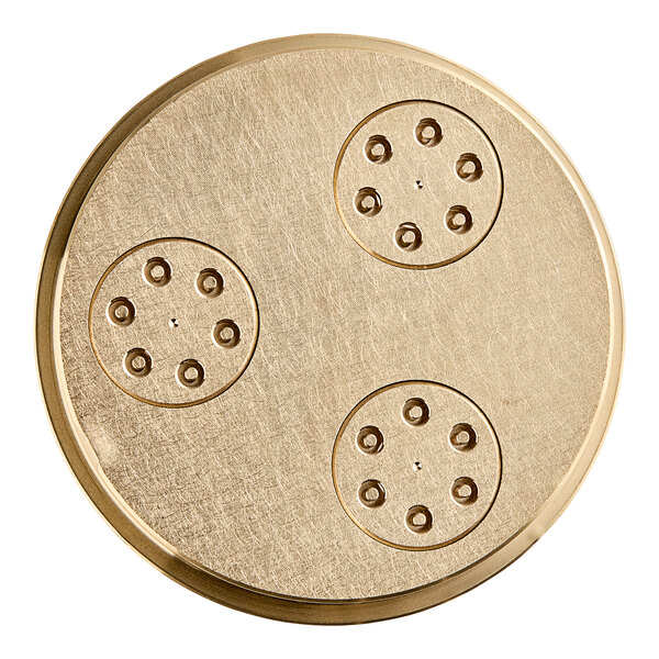 A circular gold Estella Gramigne pasta die with holes.
