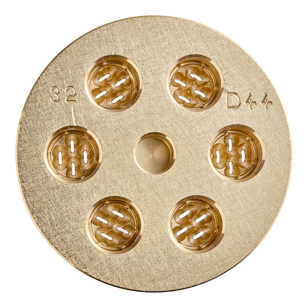 A circular gold pasta die with holes in it.
