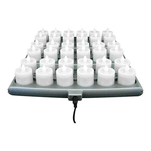 A tray of Hollowick Platinum+ clear rechargeable flameless candles on a charging tray.