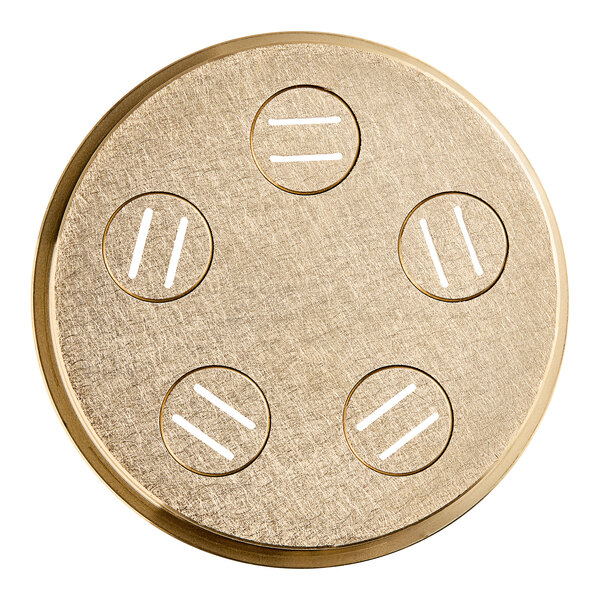 A circular gold pasta die with holes in it.