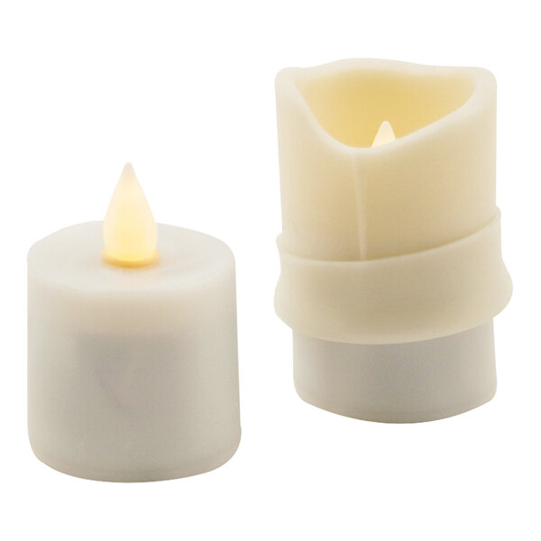 Two white candles in Ivory silicone sleeves.