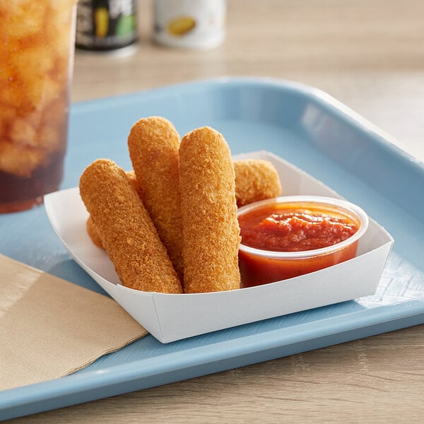 A white paper snack tray of fried sticks with red sauce on the side.