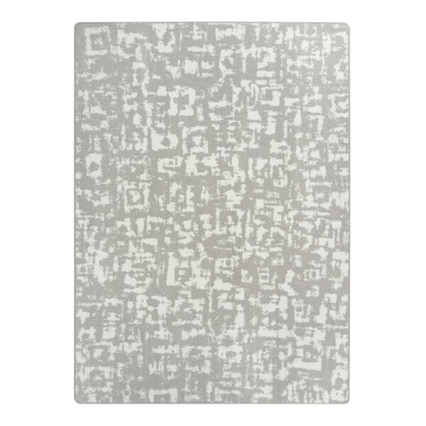 A close up of a grey and white Joy Carpets WorkSpace Block Print area rug with abstract designs.