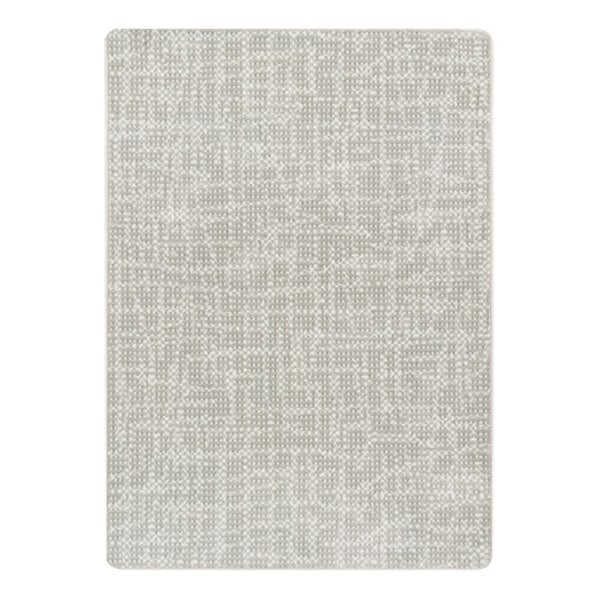 A close-up of a beige rectangular area rug with a pattern on it.
