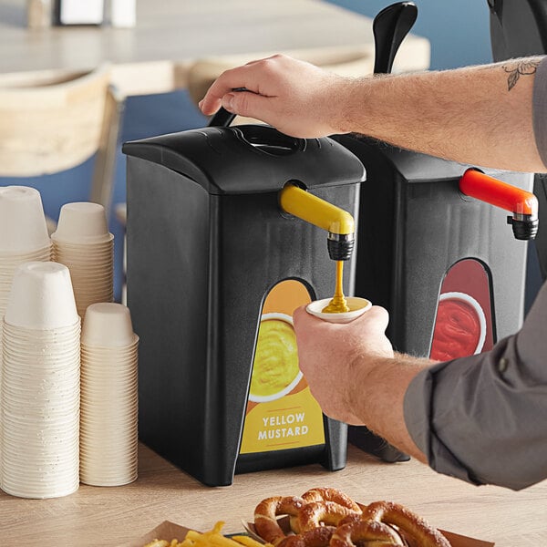 A hand pouring mustard into a ServSense mustard dispenser.