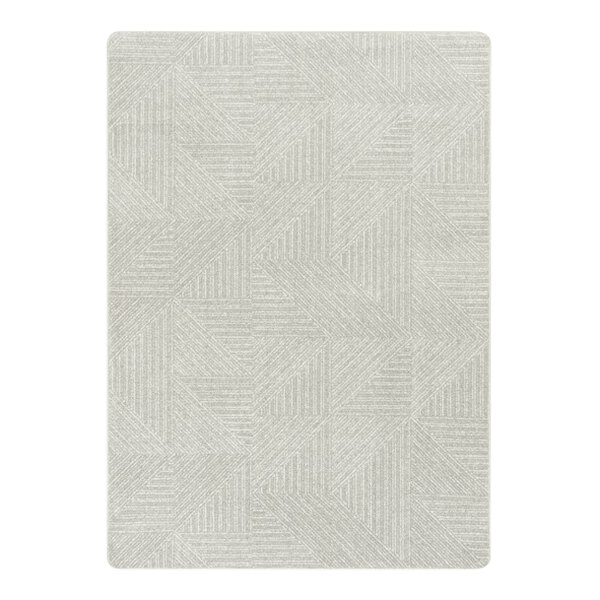 A close-up of a light grey and white rectangular area rug with a geometric pattern.