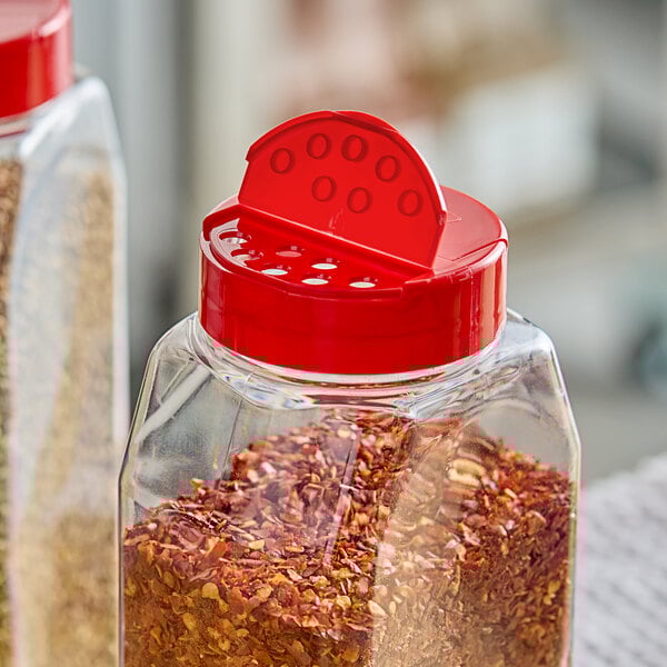 A glass jar with a red and white 53/485 dual-flapper spice lid.