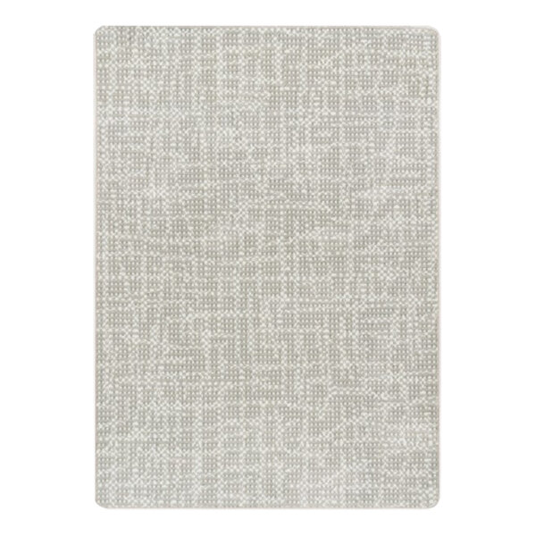 A close-up of a beige rectangle area rug with a pattern on it.