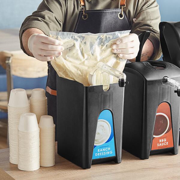 A person pouring sauce into a ServSense plastic pouch.