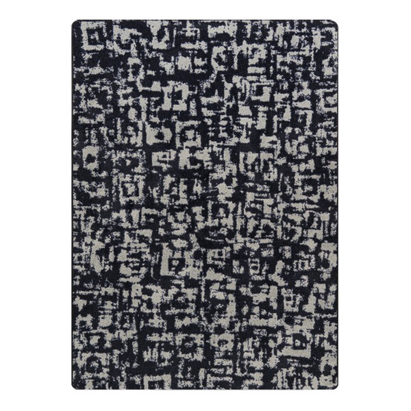 A black and white Joy Carpets area rug with abstract designs.