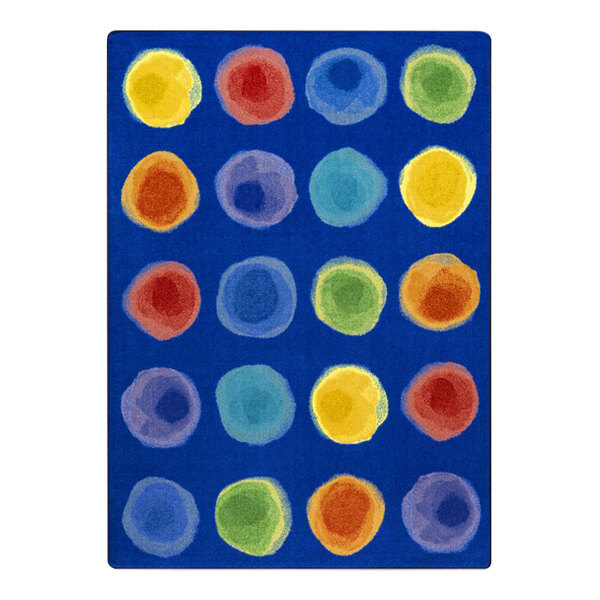 A blue rug with many colorful circles on it.