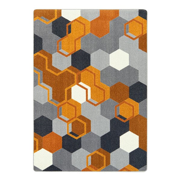 A Joy Carpets orange area rug with hexagons and squares in orange, grey, and black.