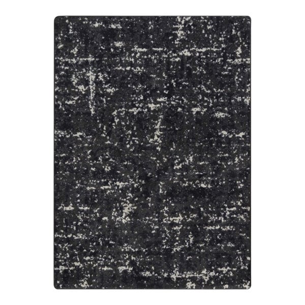 A close-up of a black and white Joy Carpets WorkSpace area rug with a distressed look.