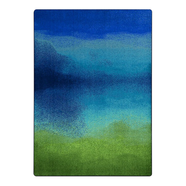 A Joy Carpets Kid Essentials Colorwash marine area rug with a gradient of blue and green colors.