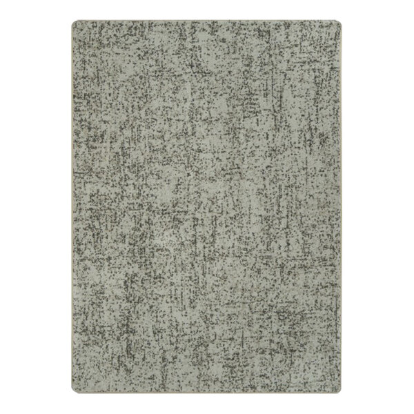 A close-up of a gray Joy Carpets Etched In Stone area rug with a patterned surface.