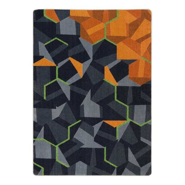 A Joy Carpets tangerine area rug with geometric shapes in orange, black and grey squares.