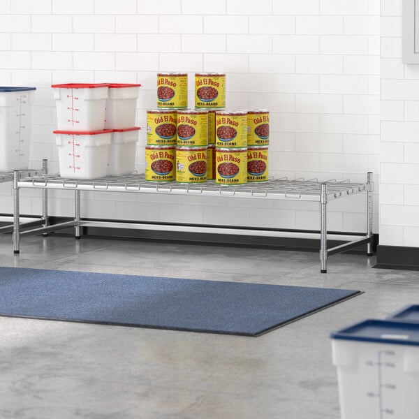 A Regency stainless steel shelving frame with cans and containers on it.