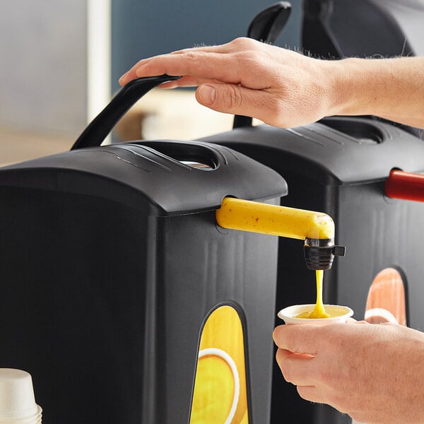 A person using a ServSense condiment dispenser to pour yellow liquid into a cup.