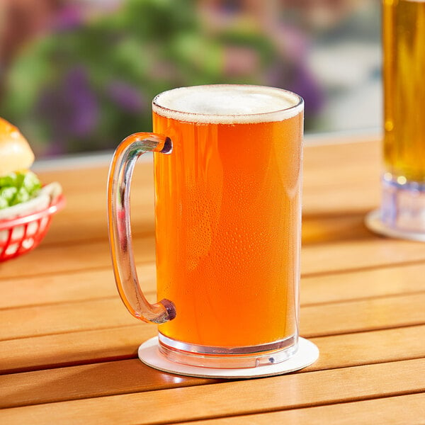 A Choice SAN plastic beer mug filled with beer sits on a table.