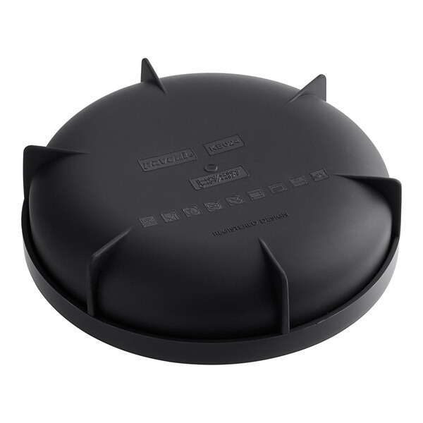 A black silicone baking mold with round compartments and spikes on the bottom.