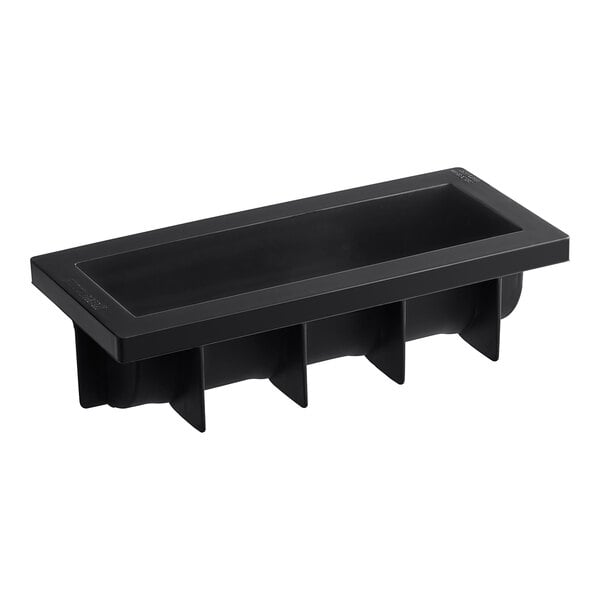 A black silicone baking mold with four Yule log compartments.