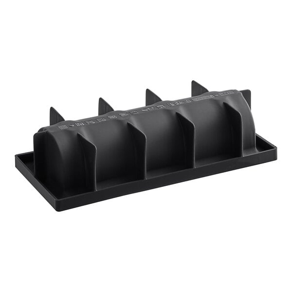 A black silicone baking mold with four Yule log compartments.
