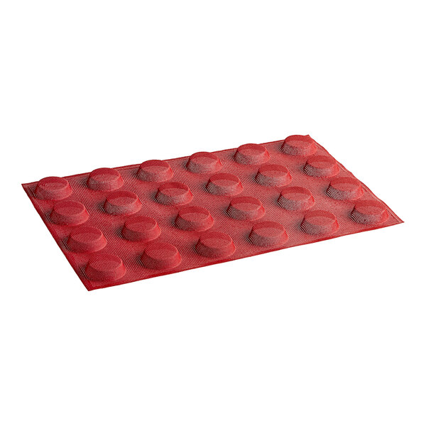 A red silicone baking mold with round circles.