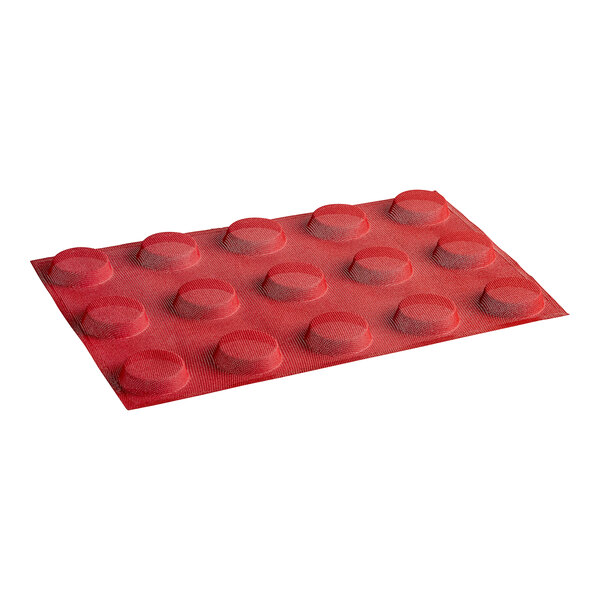 A red silicone mold with round circles and micro-perforations.