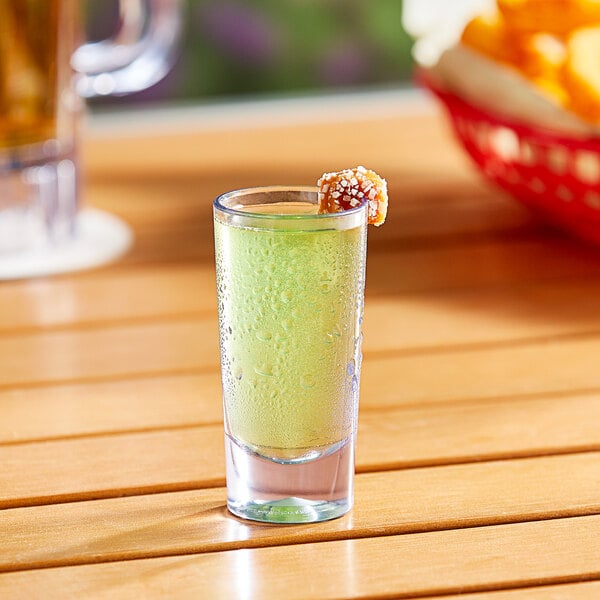 A Choice SAN plastic shooter filled with a drink on a table.