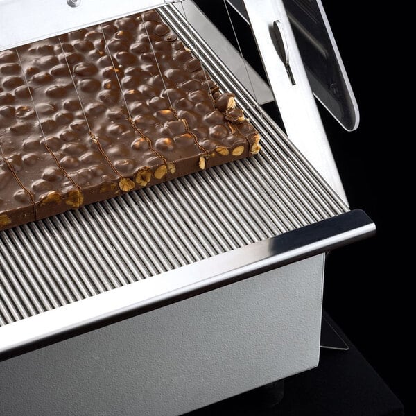 A chocolate bar on a Pavoni Lira manual slicer.