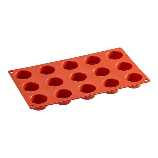 A red silicone Pavoni muffin baking mold with 15 compartments.