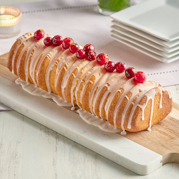 A cake baked in the Pavoni Pavocake Sequoia silicone baking mold with cranberries on top.