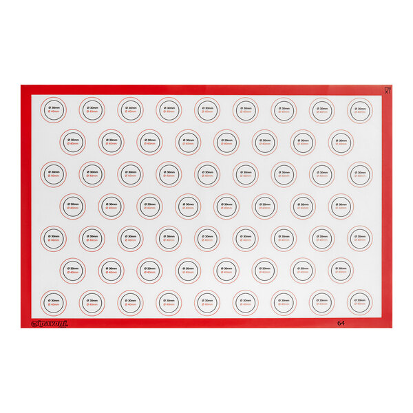A white rectangular silicone baking mat with red circles.
