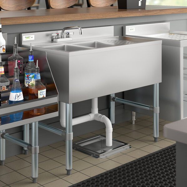 A Regency stainless steel underbar sink with a right drainboard on a counter.