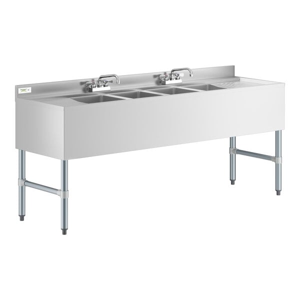 A Regency stainless steel underbar sink with 4 bowls, 2 faucets, and 2 drainboards.