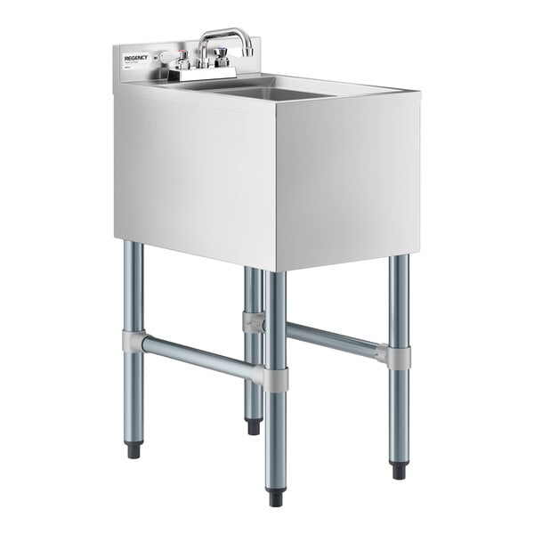 A stainless steel sink with a single deep basin, four sturdy legs, and a faucet mounted on a backsplash panel.