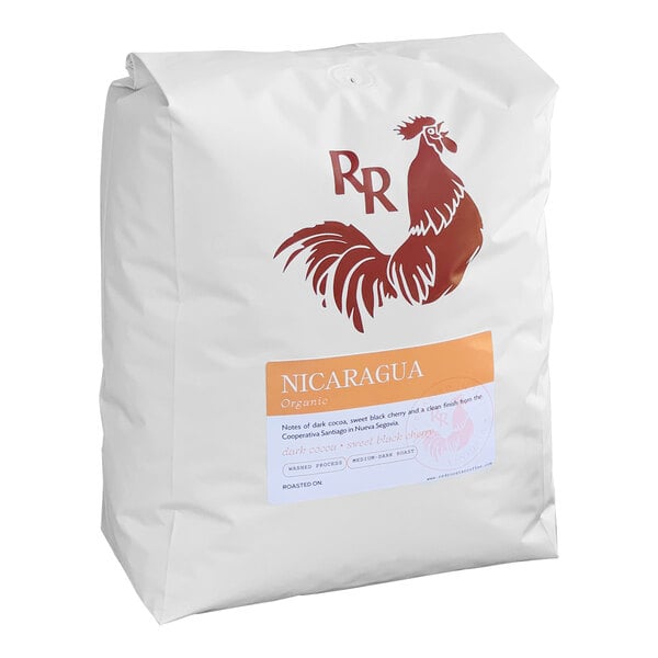 A white bag of Red Rooster Organic Nicaragua Whole Bean Coffee with a red logo.