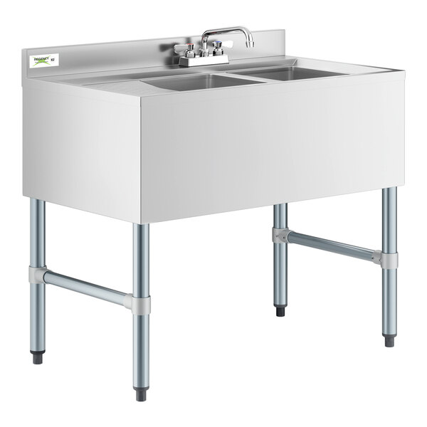 A Regency stainless steel underbar sink with 2 bowls, faucet, and left drainboard.