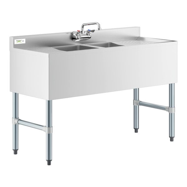 A Regency stainless steel underbar sink with two bowls, faucet, and drainboards.