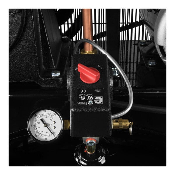 A close up of a pressure gauge on a machine with a white background.
