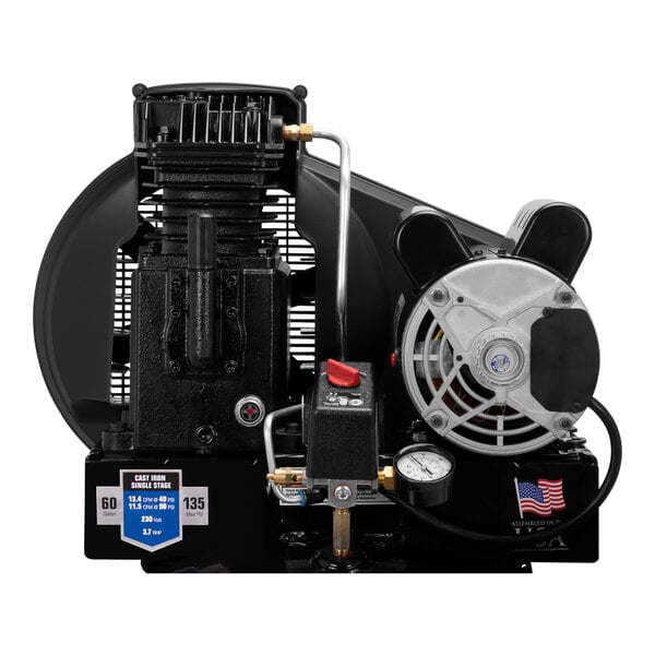 An Industrial Air vertical air compressor with a round black engine, gauge, and hose.
