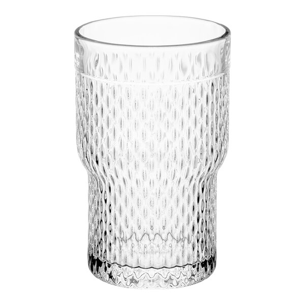 A close-up of a clear Acopa Rivulet beverage glass with a textured pattern.