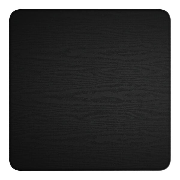 A black square table surface with a white spot in the middle.