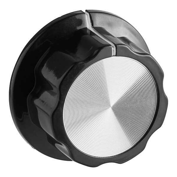 A black and white knob with a silver circle.