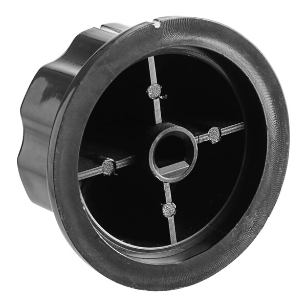 A black plastic circular knob with four holes.