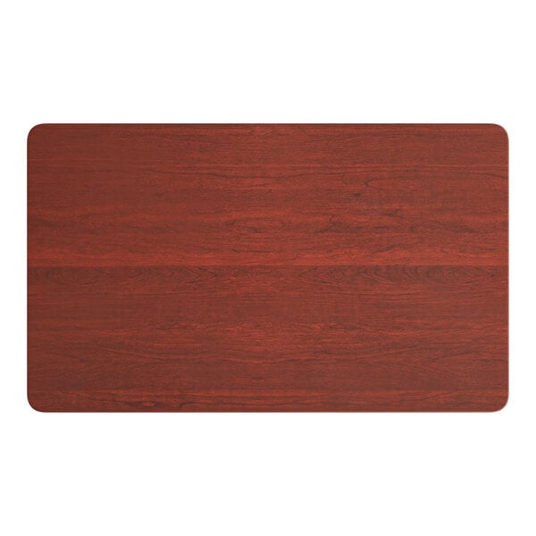 A rectangular Lancaster Table & Seating wood table top with a red mahogany finish.