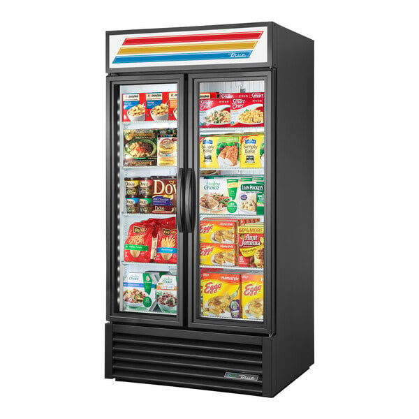 A black True glass door merchandiser freezer with a variety of products inside.