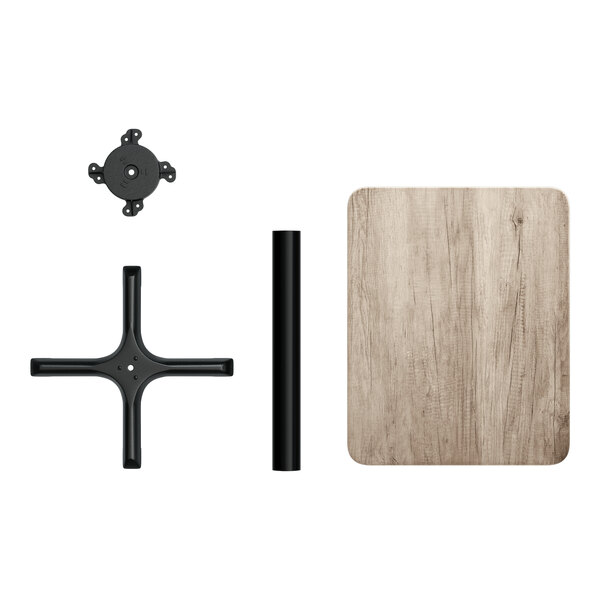 A disassembled rectangular table with a gray wood finish top and black metal base components.