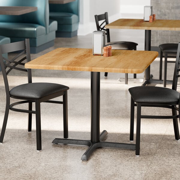 A wooden table with a table top in a restaurant dining area.