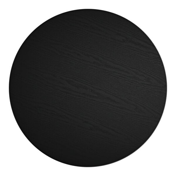 A black circle on a white surface.